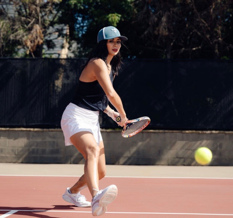 women tennis hat backhand return serve court